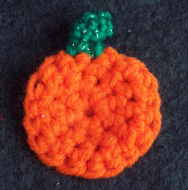 Make a crochetd pumpkin pin with free pattern and instructions from Craft Elf